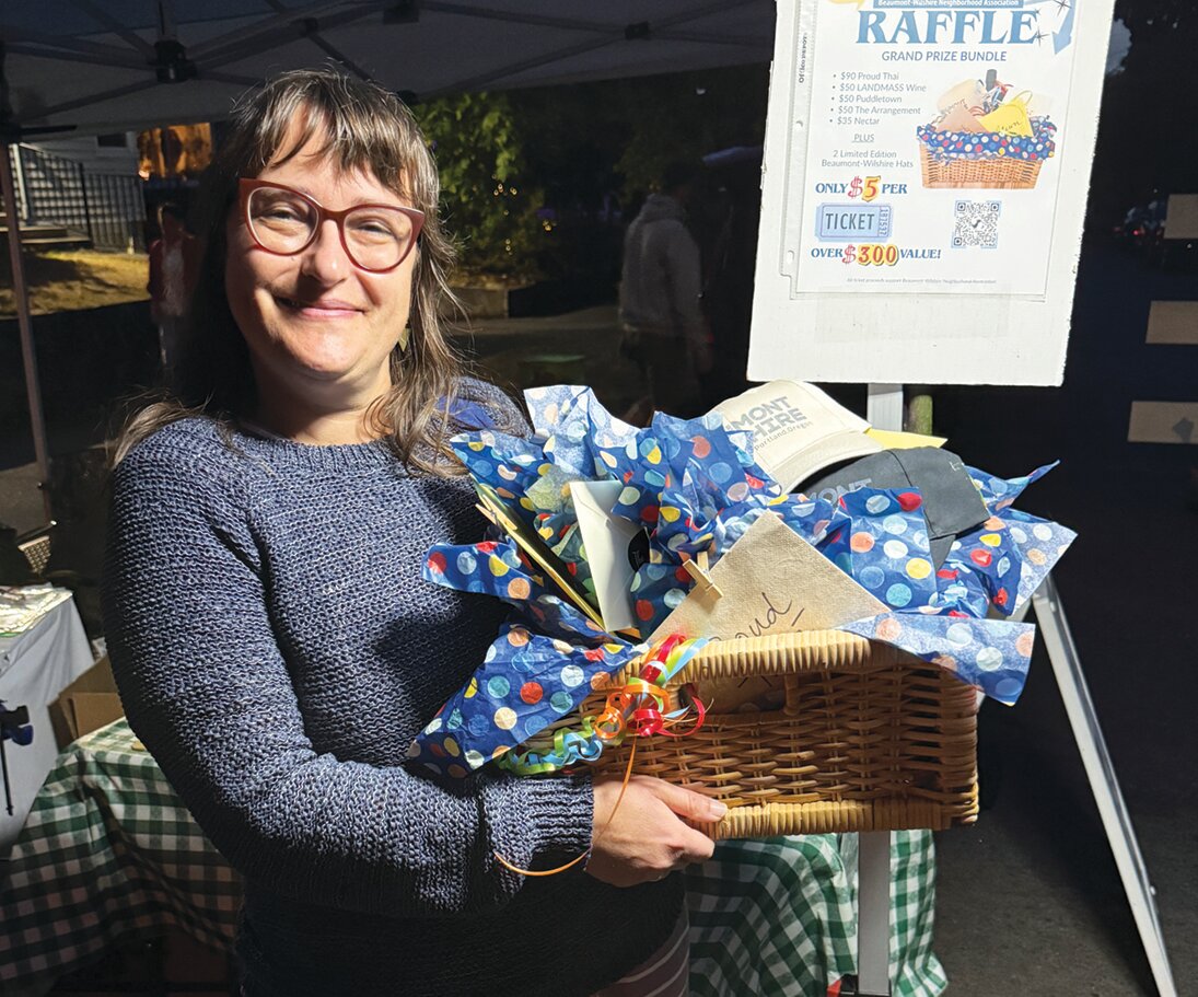 Katie Myszka holding the raffle basket.